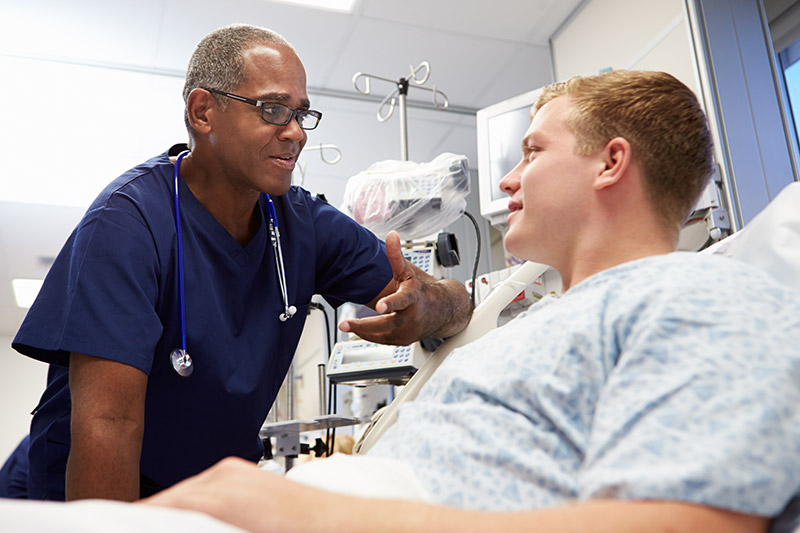 Photo of doctor conversing with patient