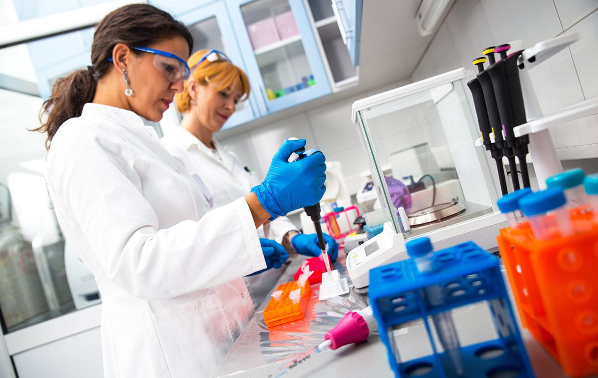 Photo of two scientists working in lab