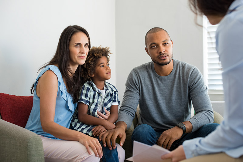 Photo of family talking with a counselor